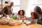 Family shown with reusable shopping bags.